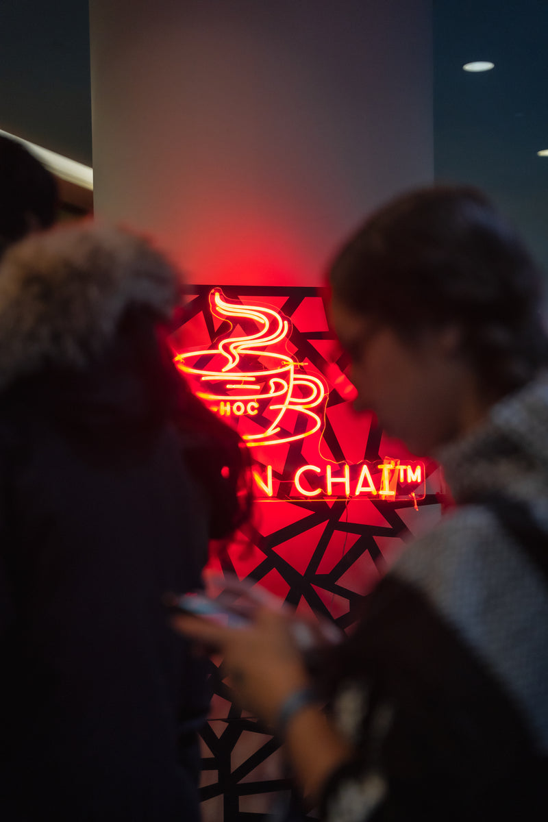 Neon sign with red and black design in a dark setting